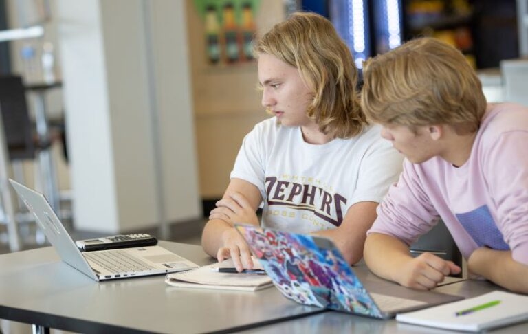 High school students working on lap top