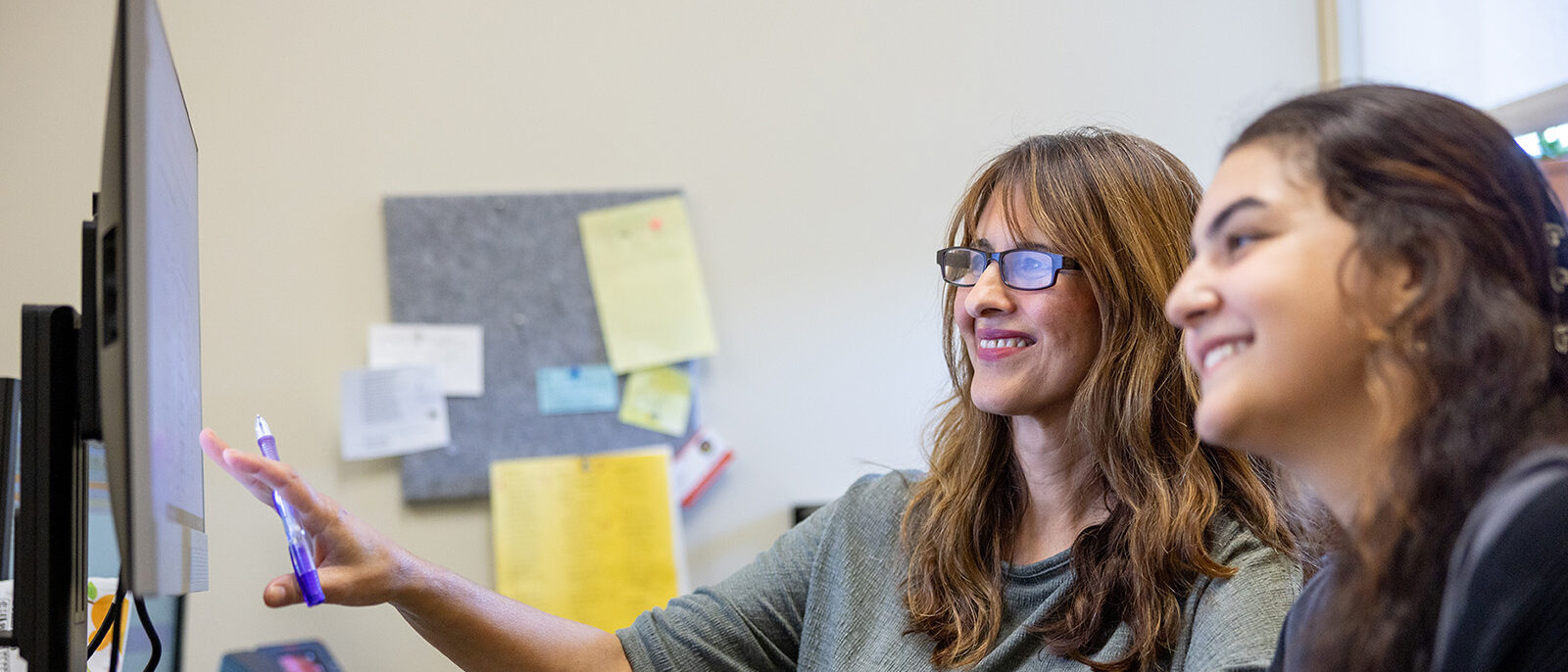 Female advisor working with female student
