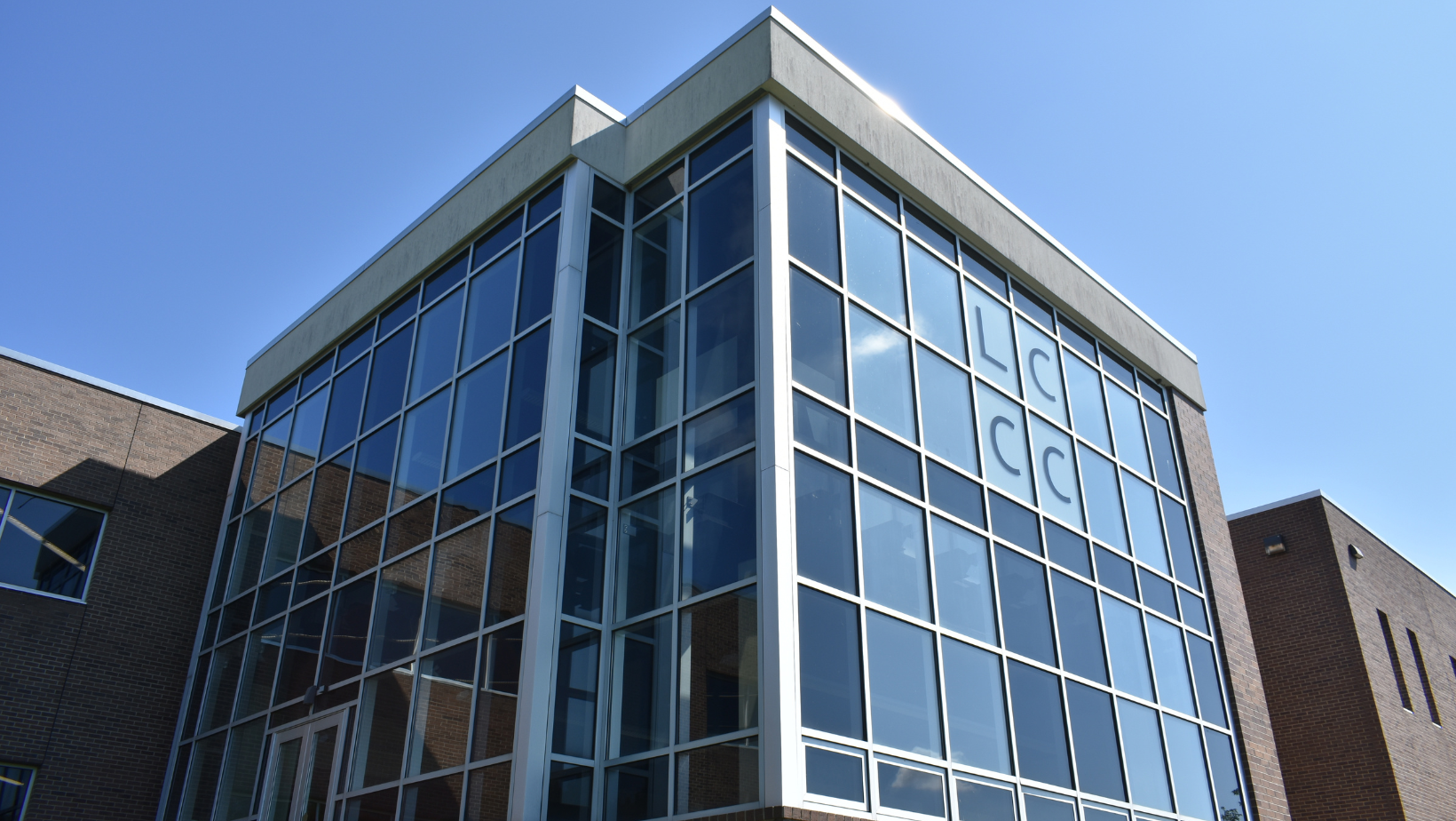 The exterior of the Glass Box Gallery shines in the sunlight.