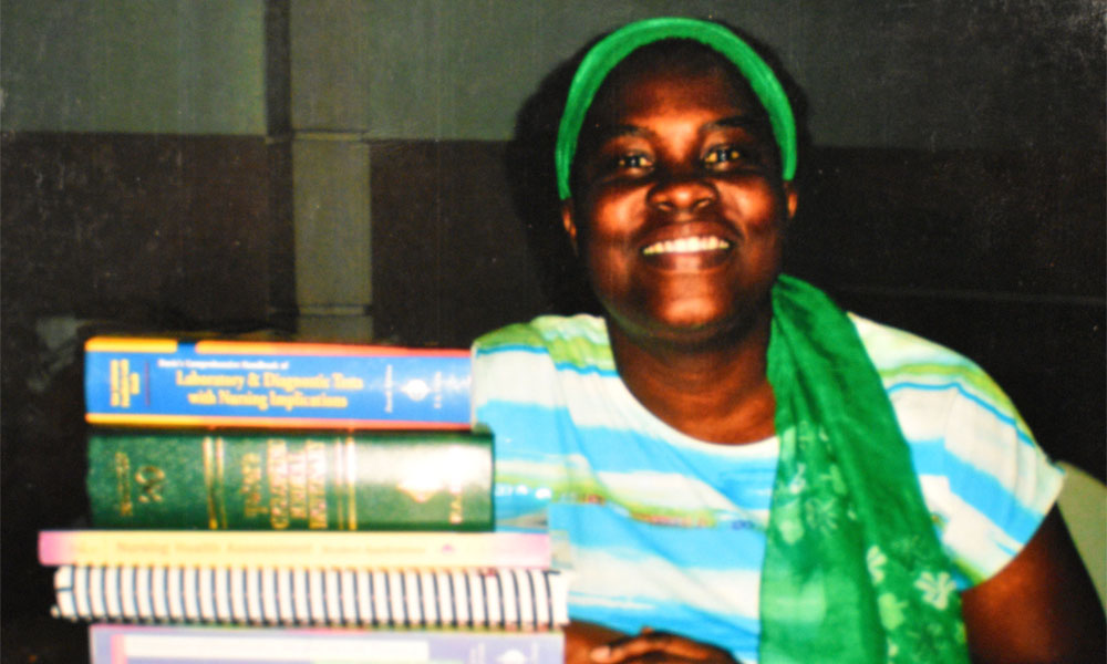 Nursing school administrator with donated books in Haiti.