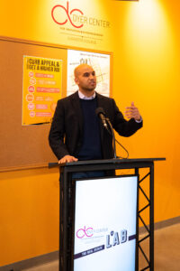 A man speaks from a podium.