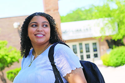 female student in front of library