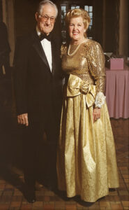 A man and woman side by side in formal attire.
