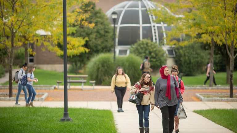 Image shows students walking on the Main Campus mall area.