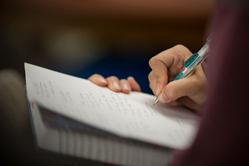 Person writing notes in a notebook.